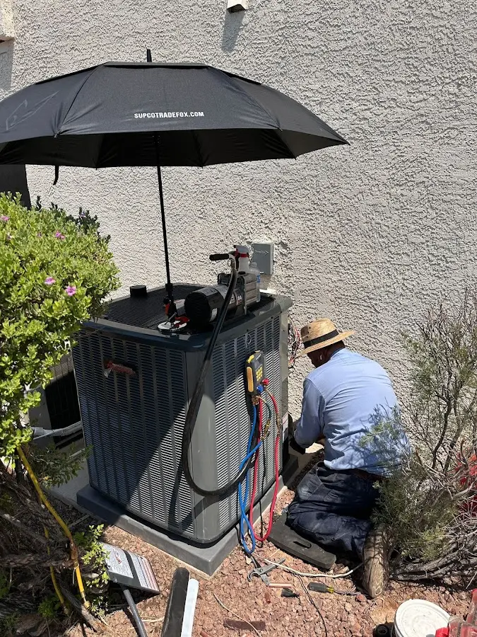 HVAC technician performing outdoor AC maintenance in East Bethel